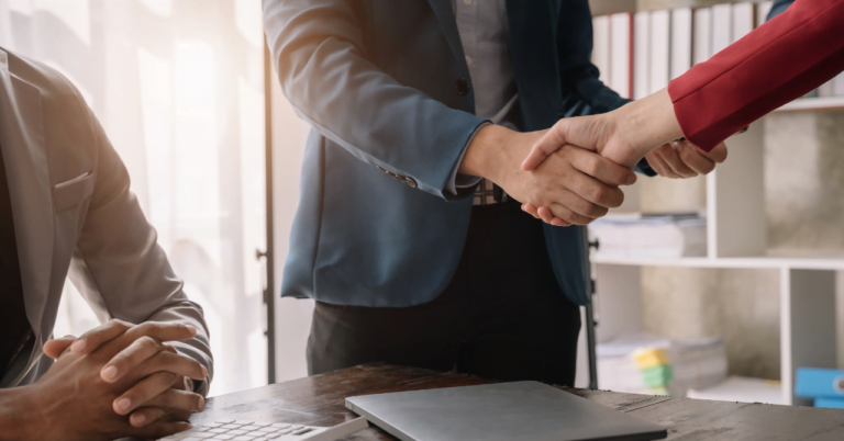 Business handshake at office meeting.