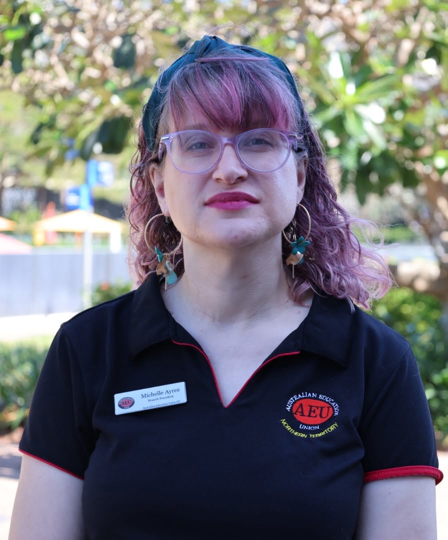 Woman with glasses and AEU polo shirt.